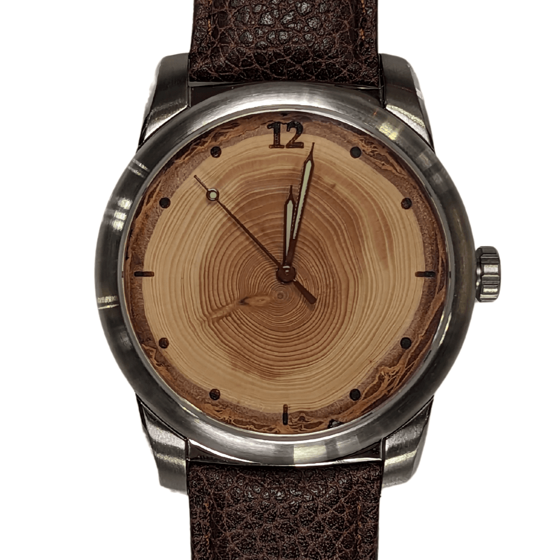 Tree ring watch with leather strap, showcasing natural wood grain matching recipient's special year.