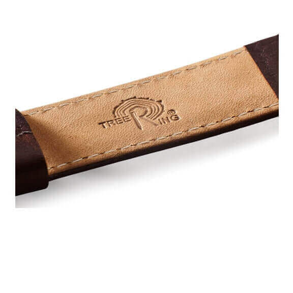 Tree Ring logo embossed on leather strap of a watch, symbolizing natural craftsmanship and authenticity.