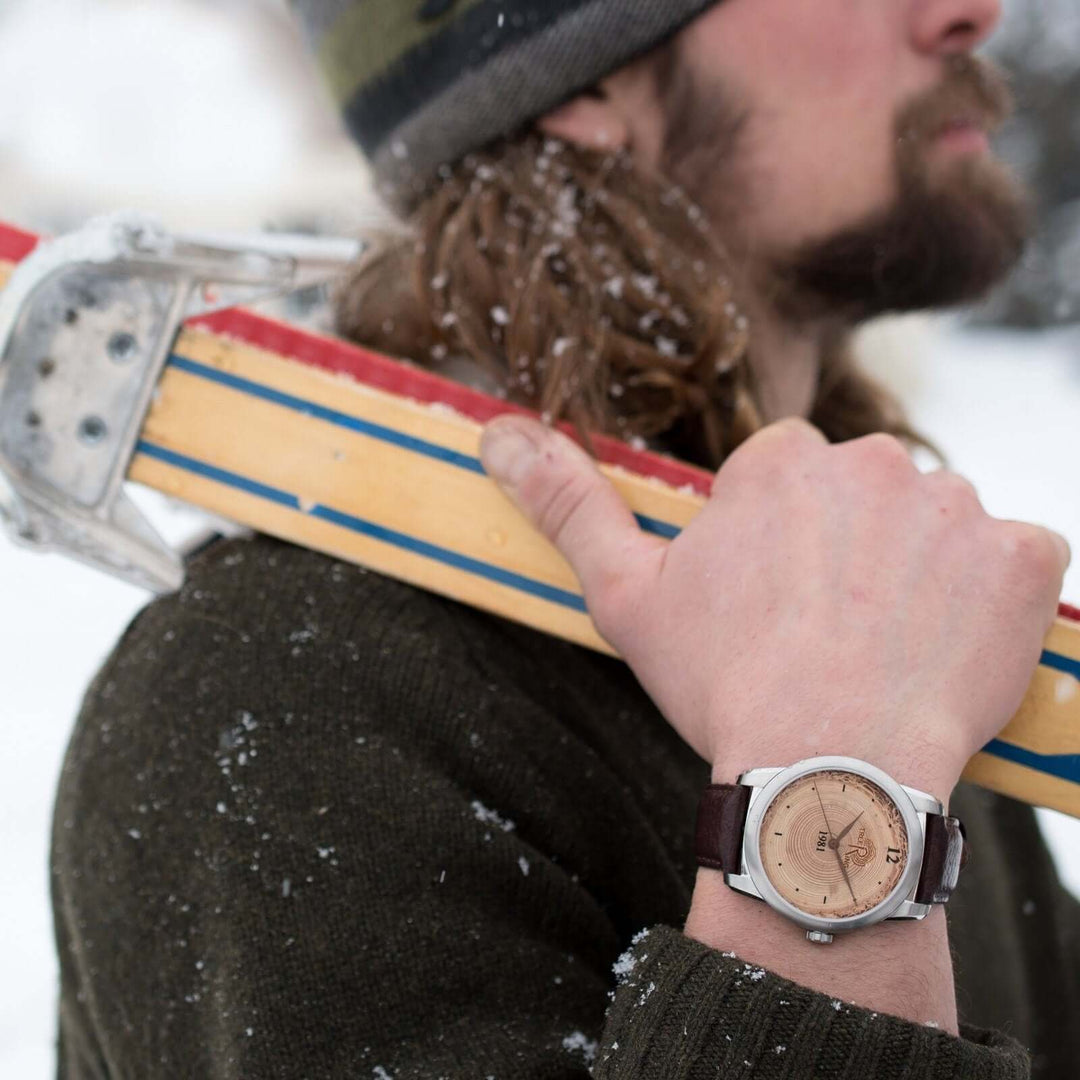 Colorado Bison Gift Watch featuring Mother of Pearl inlay, worn by a man holding skis in snowy landscape.