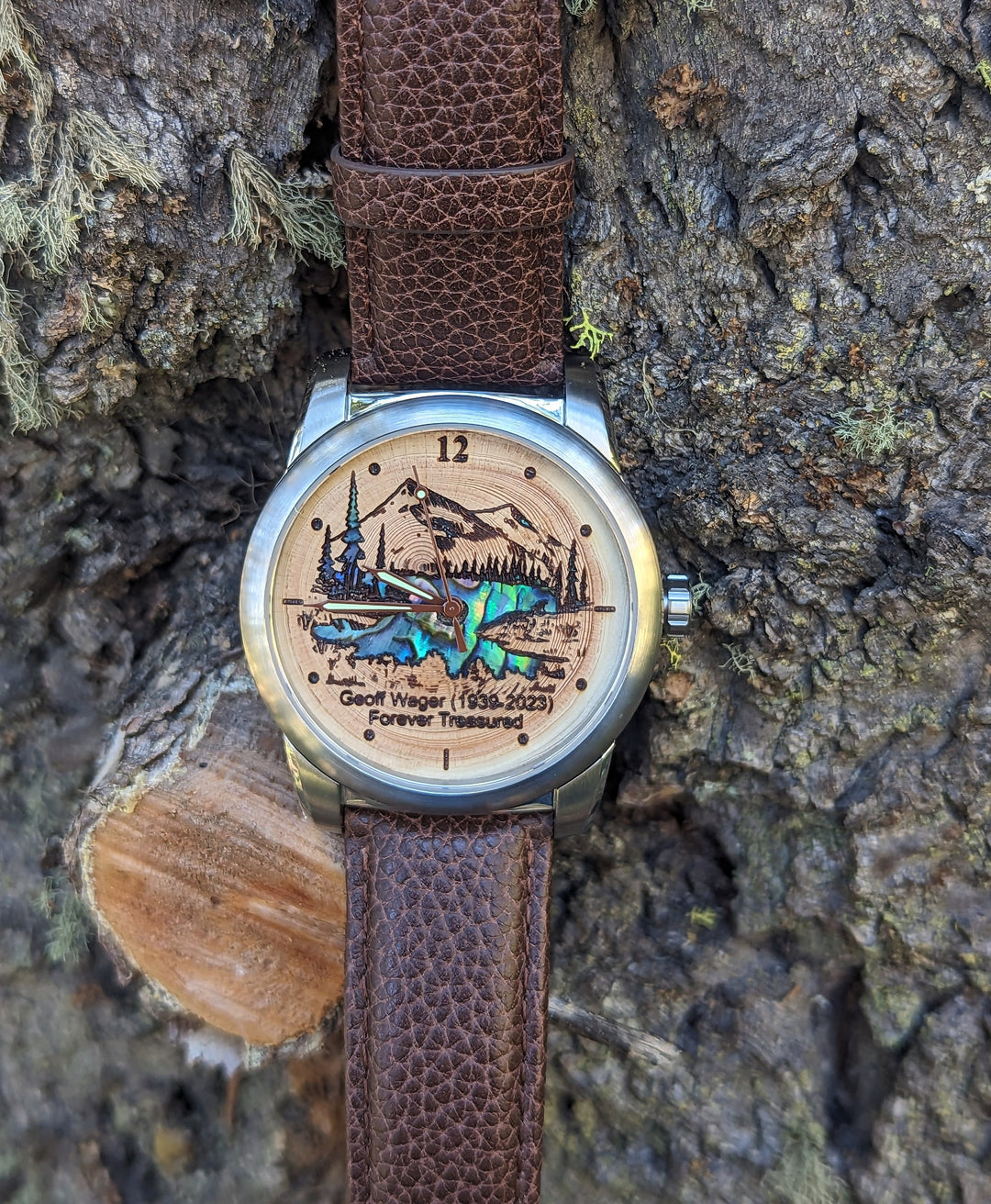 Tree Ring Urn Watch featuring mother of pearl inlay, personalized engraving, and mountain scene on leather strap.